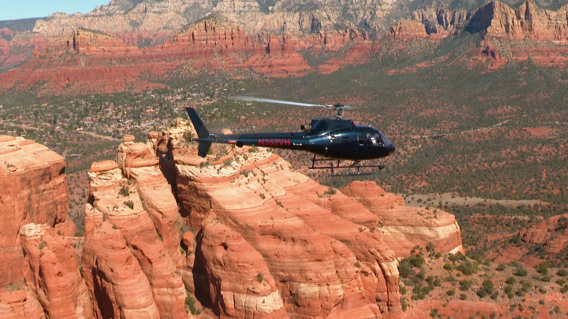 Apex Air Tours helicopter flying over Cathedral Rock in Sedona